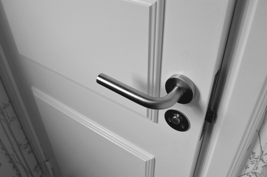 A white door with a silver door handle