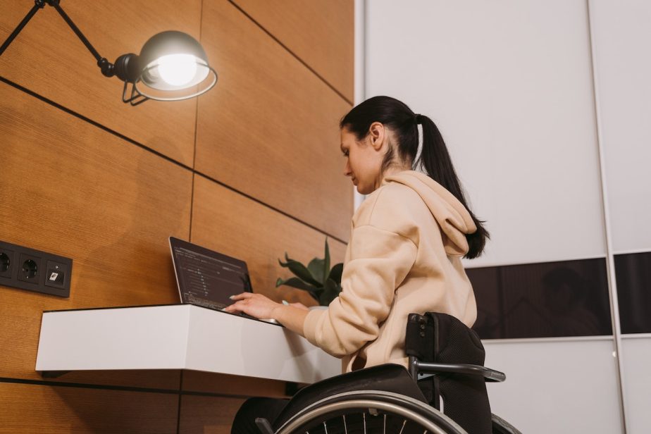 A woman in a wheelchair using a laptop