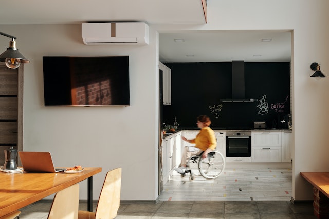 A woman in a wheelchair in a kitchen with no door